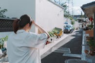 Girl Wandering Through a Sunny Alleyway
