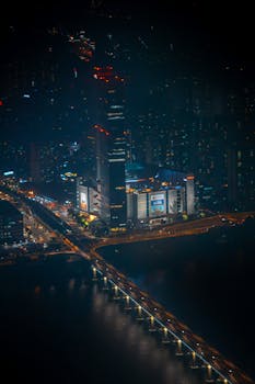 Stunning aerial view of Seoul at night showcasing vibrant city lights and bustling urban landscape.
