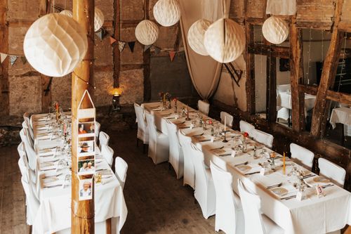 Free Beautifully decorated rustic barn setting with table arrangements for a special event. Stock Photo