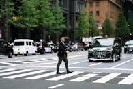 Businessman Crossing City Street in Japan