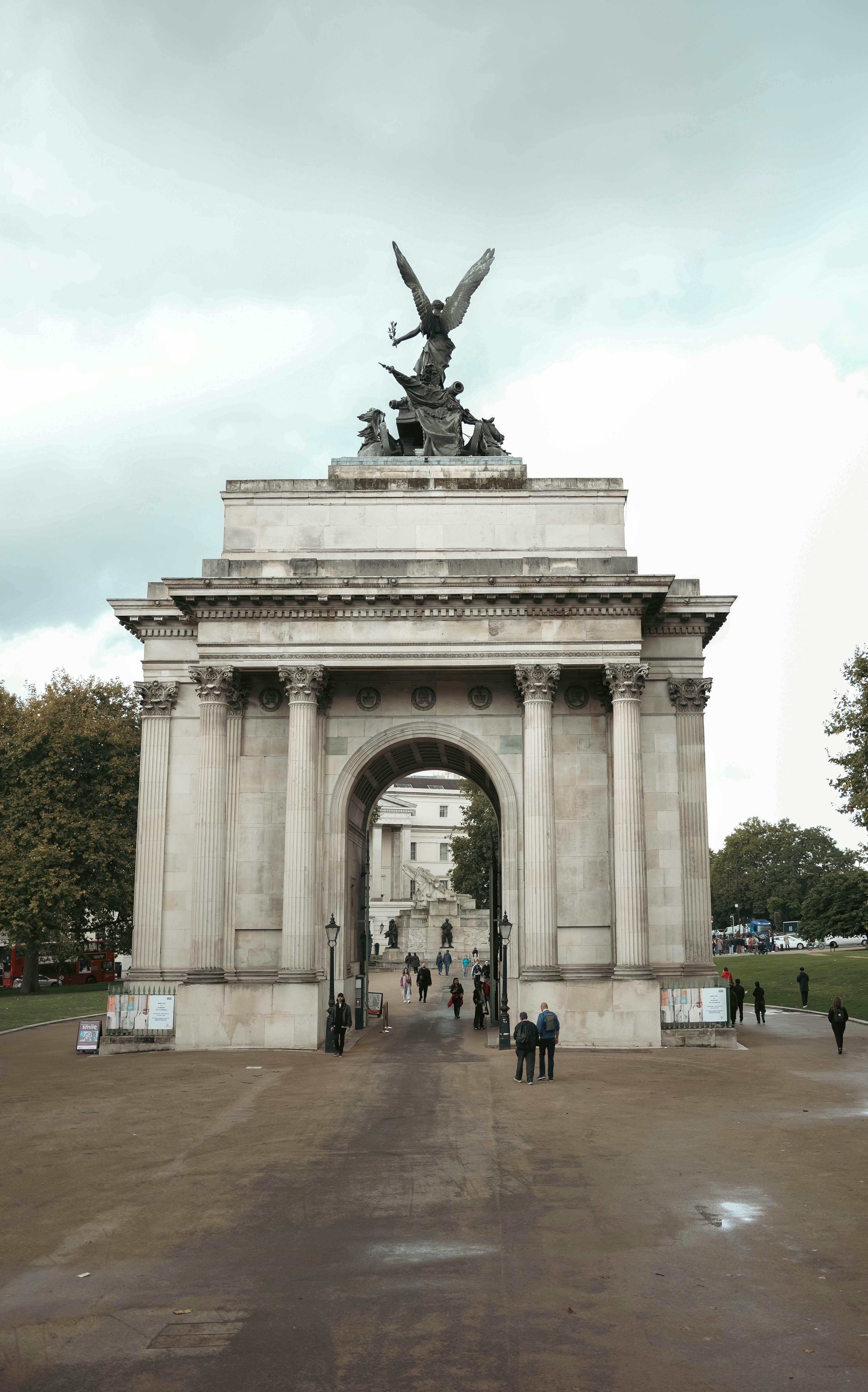 Majestic view of Wellington Arch in London, capturing its neoclassical design and urban surroundings on a cloudy day.