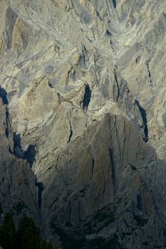Close-up of rugged mountain textures in bright daylight, showcasing natural geological formations.