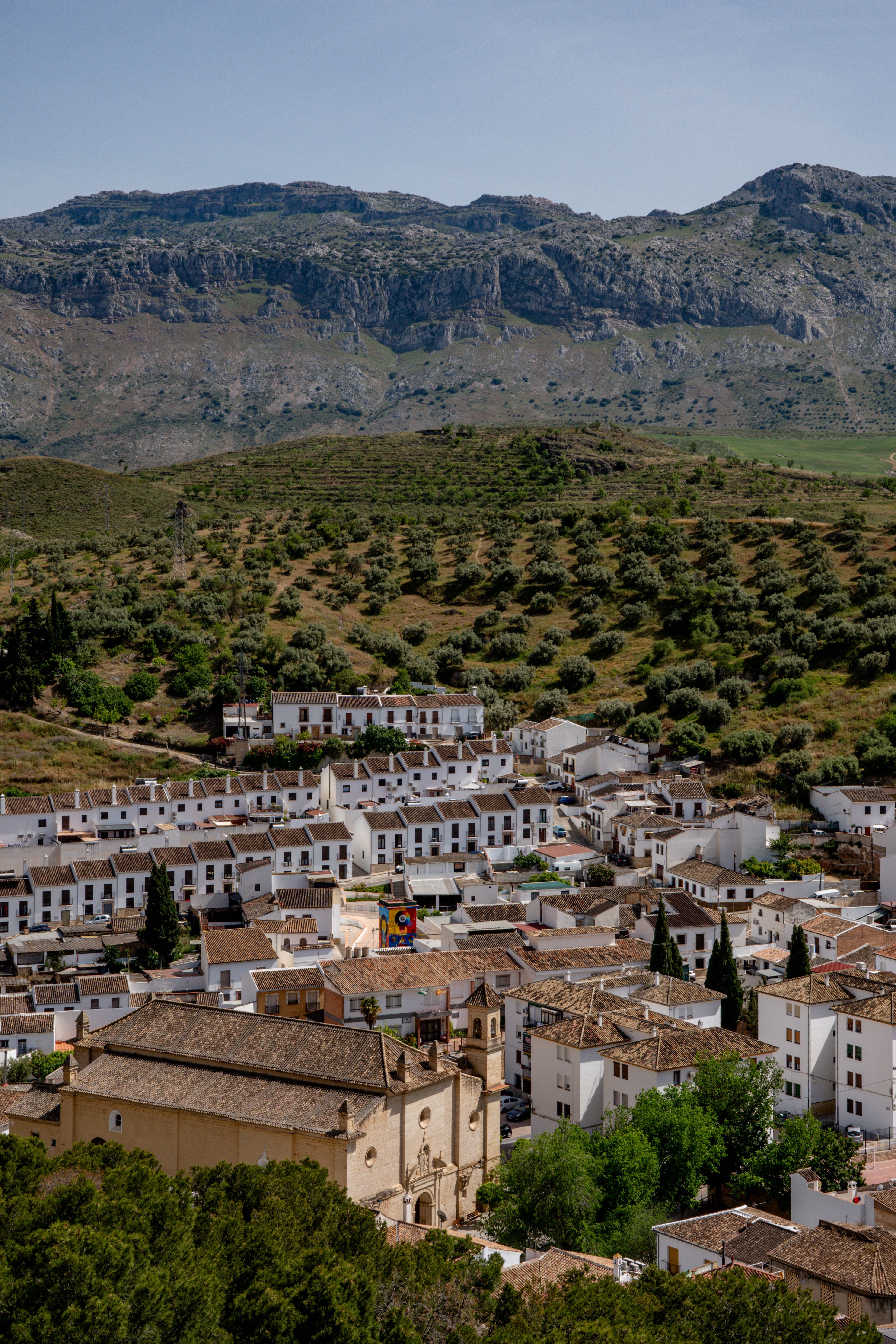 Aerial view of the charming white buildings of Antequera with mountainous backdrop in Andalusia, Spain.