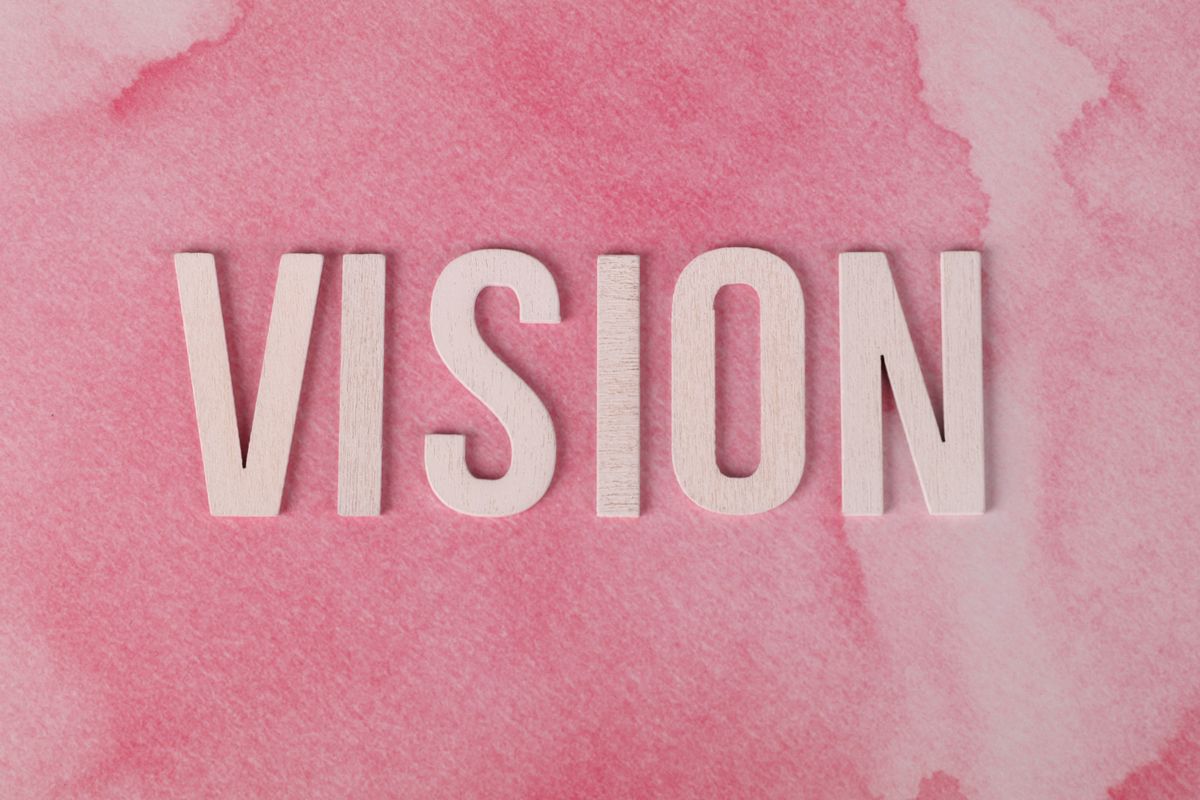 Vision Concept with Pink Watercolor Background