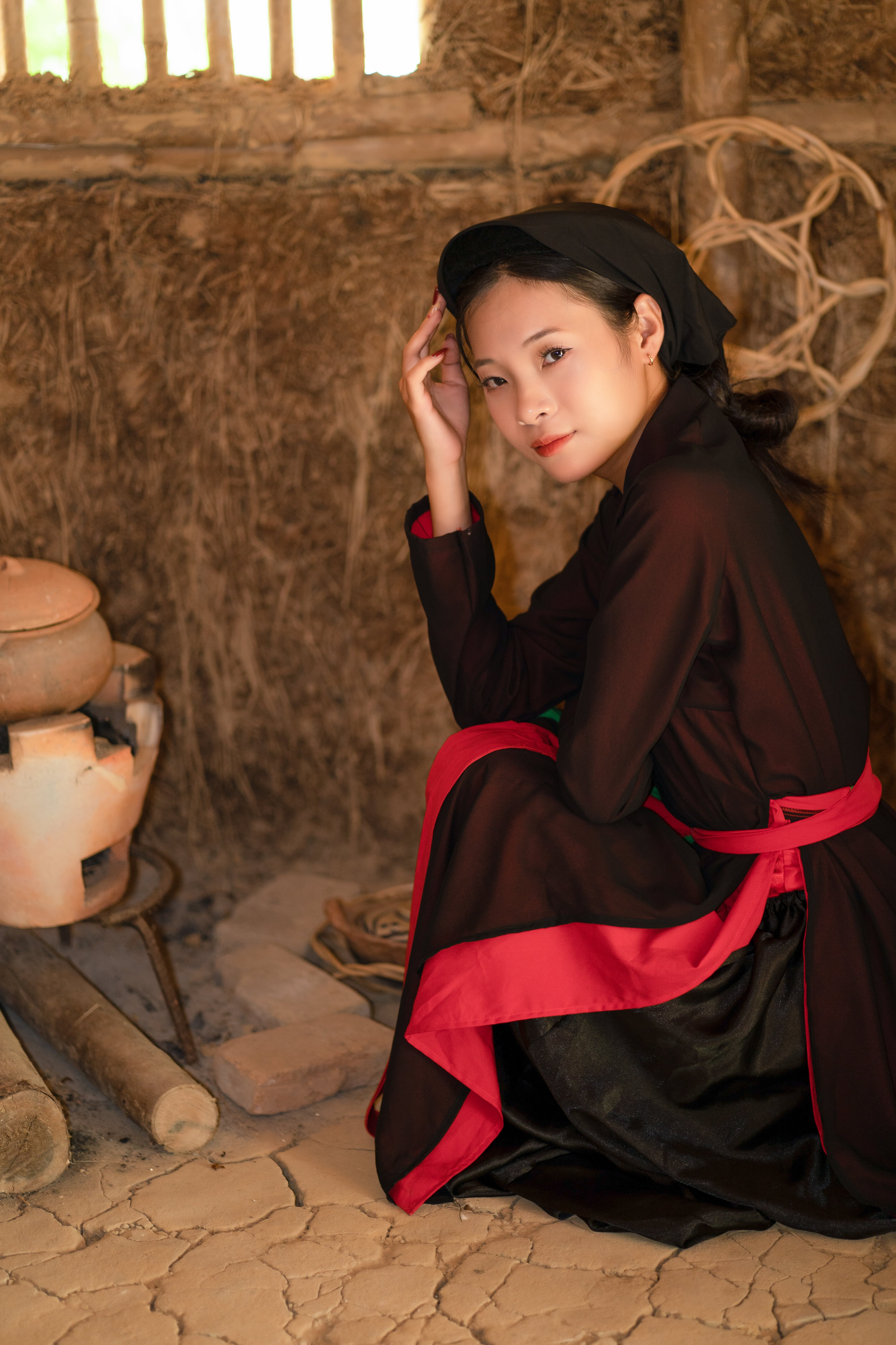 Young woman in traditional Vietnamese clothing seated indoors.