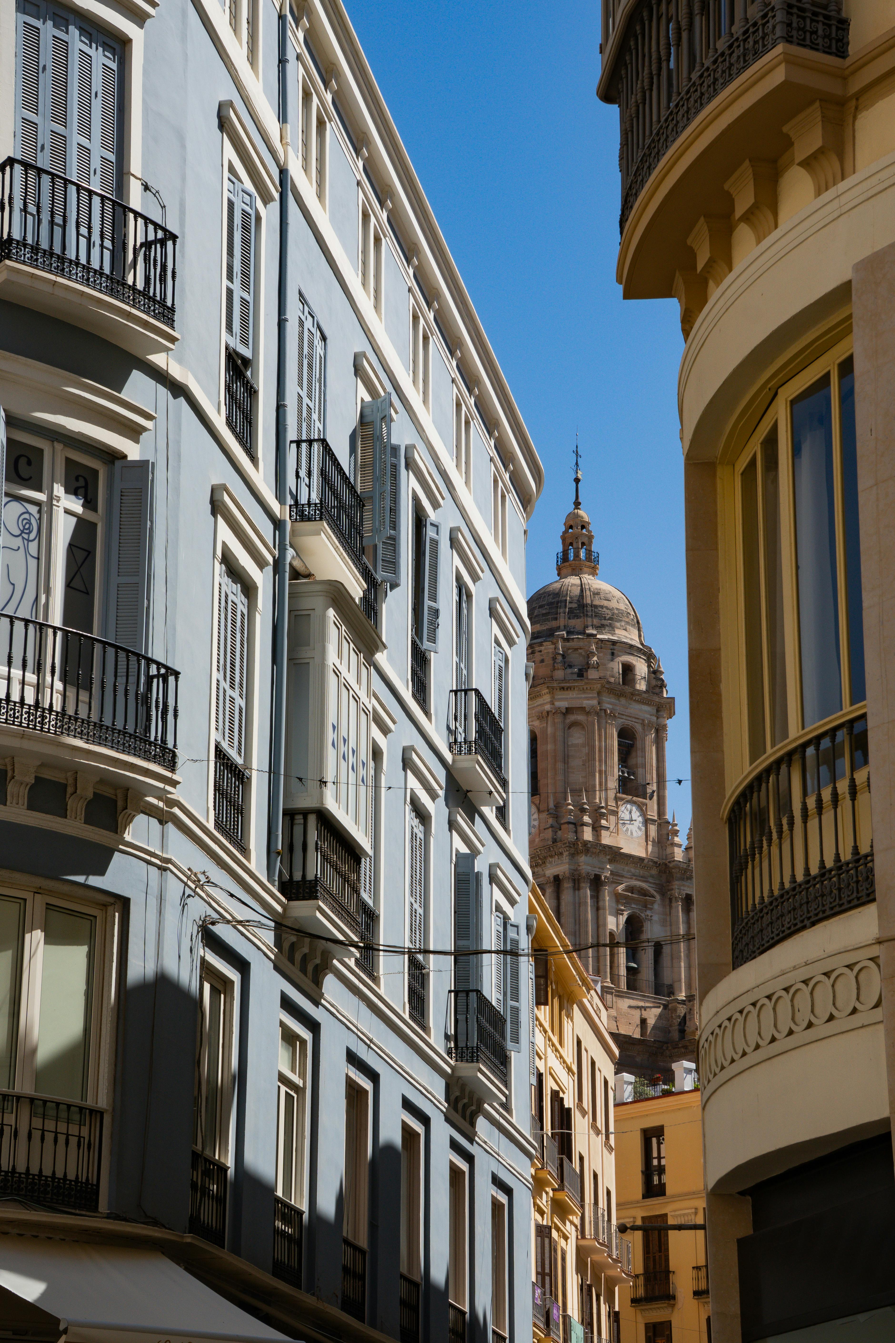Discover Málaga's architectural beauty with a view of its iconic cathedral towering above pastel buildings.