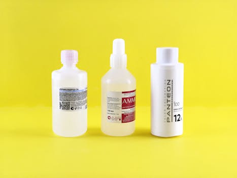 Three bottles with labels on a vibrant yellow surface emphasizing chemical substances.