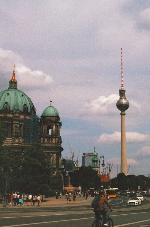 Free View of Berlin's iconic TV Tower and Cathedral with Berliners biking and strolling. Stock Photo