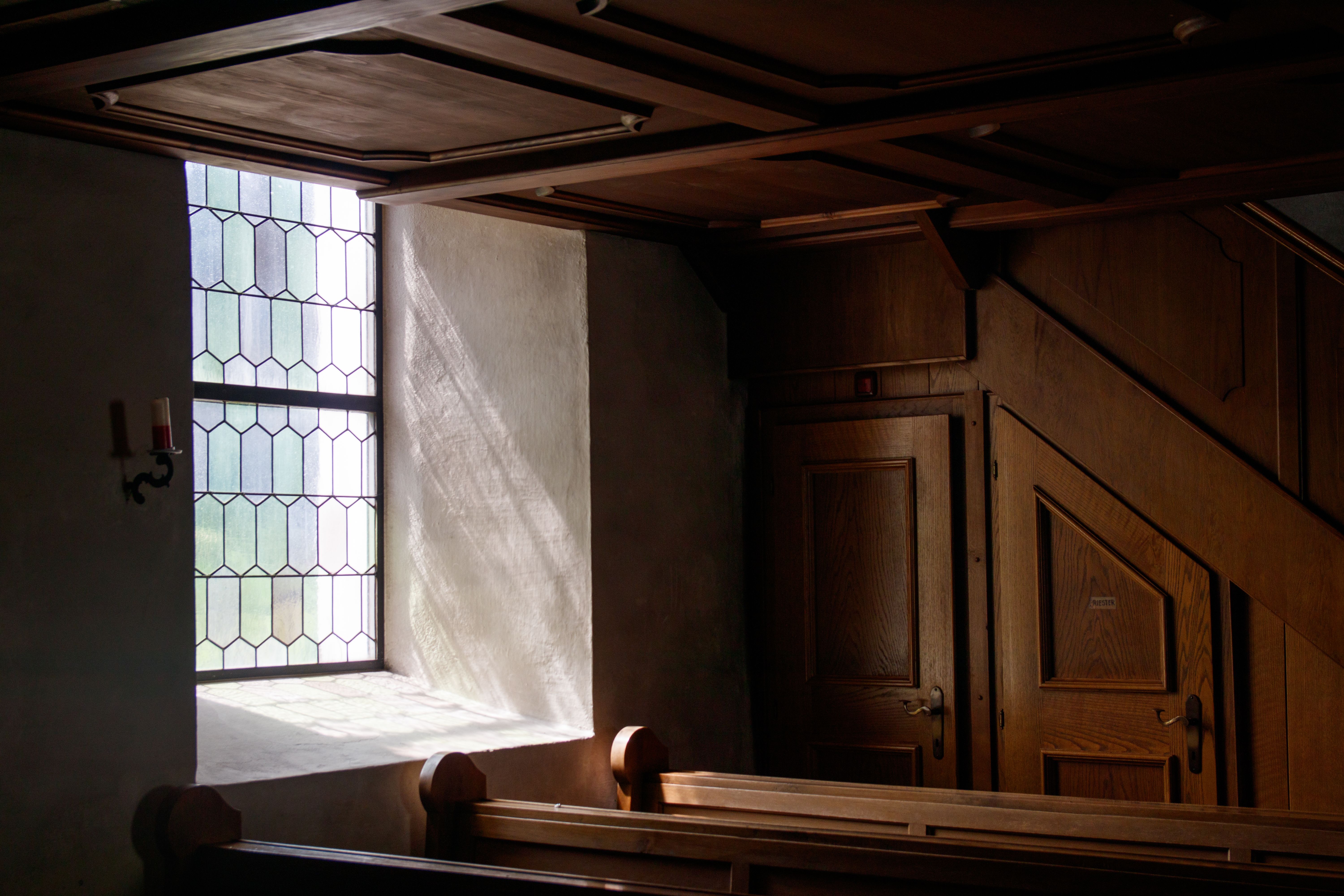 Interior of the Evangelical Presbyterian Church Bankoe with sunlight through stained glass windows