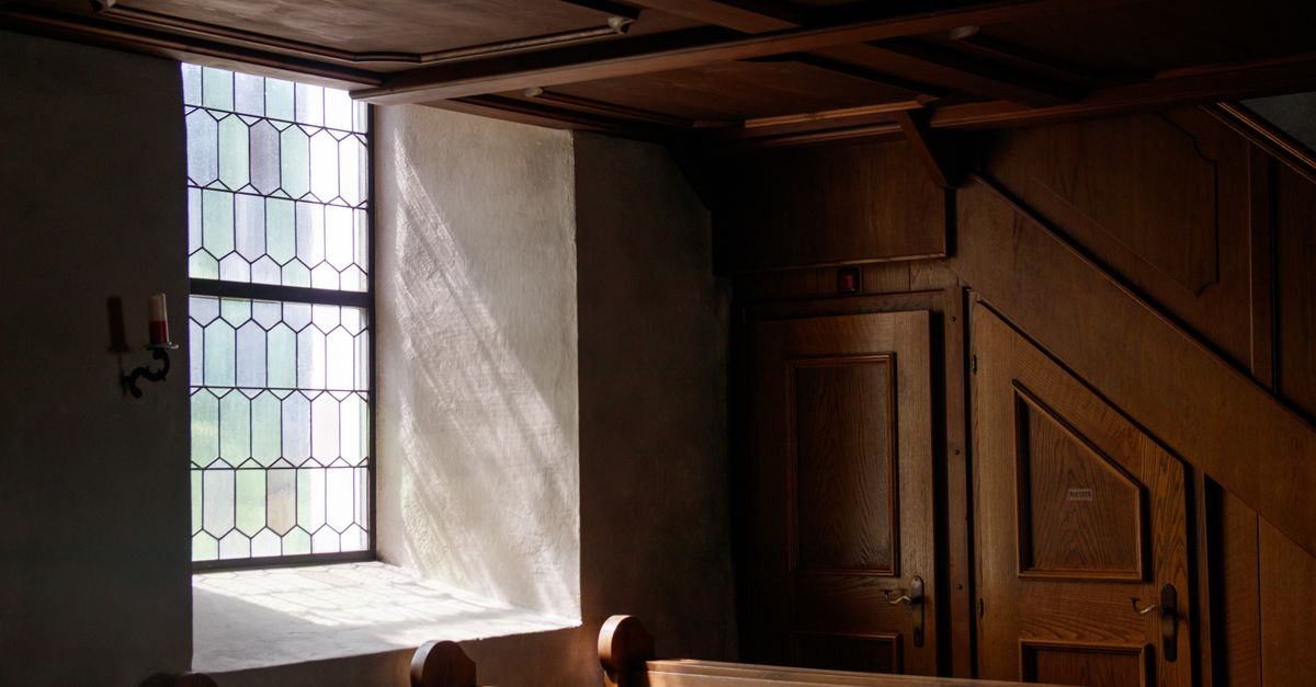 Interior of the Evangelical Presbyterian Church Bankoe with sunlight through stained glass windows