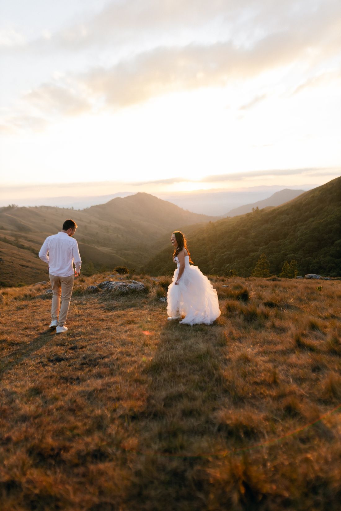 Newlywed couple by a mountain lake