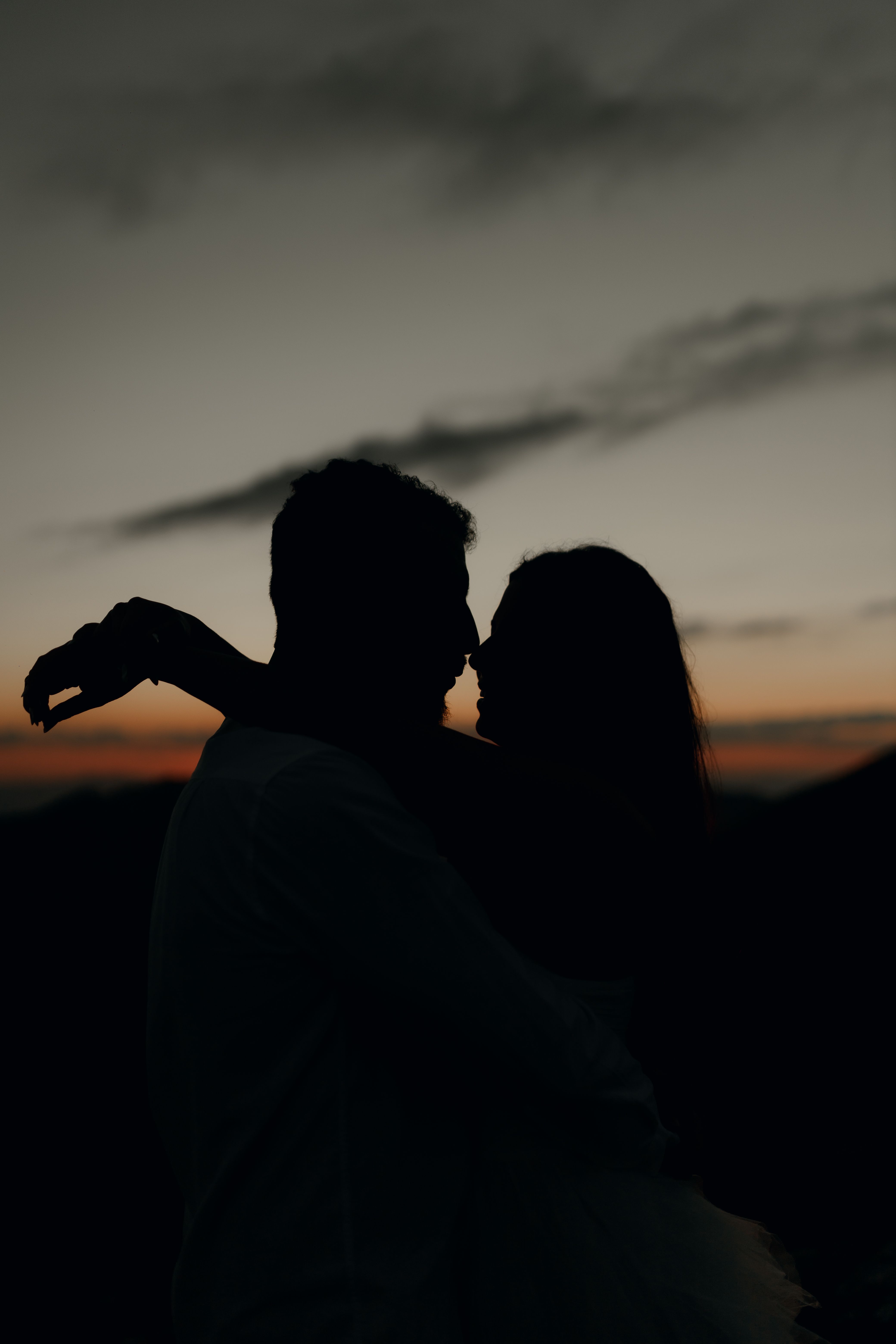 Silhouette of Couple Embracing at Sunset · Free Stock Photo
