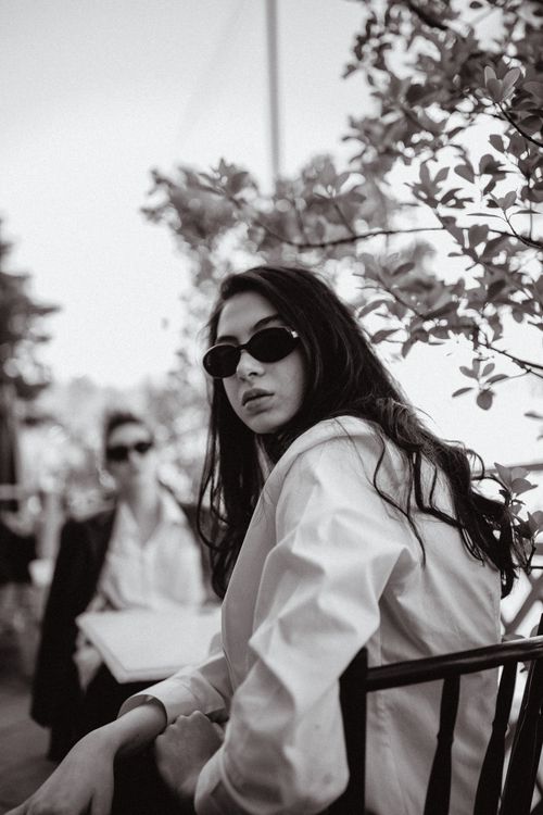 Free Stylish black and white portrait of a woman wearing sunglasses outdoors. Stock Photo