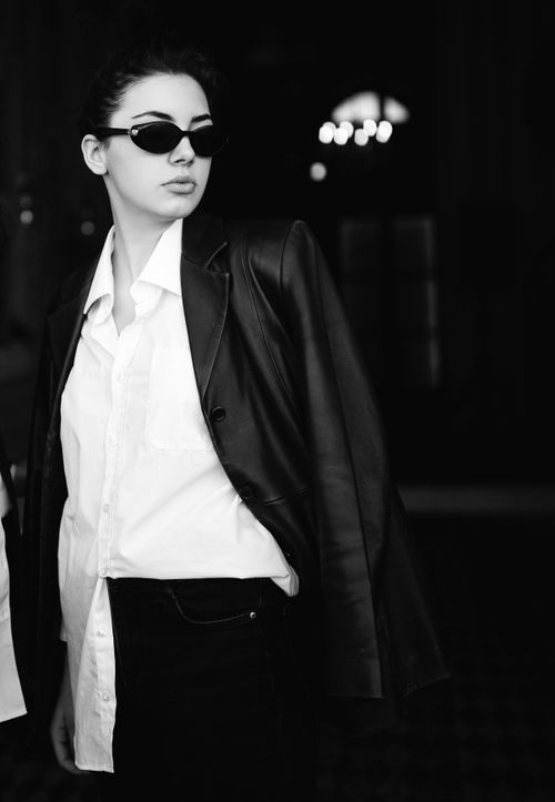 Free Stylish woman in sunglasses and blazer, captured in a moody black and white editorial style. Stock Photo