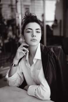 Vintage-inspired monochrome portrait of a thoughtful woman exuding elegance and style.