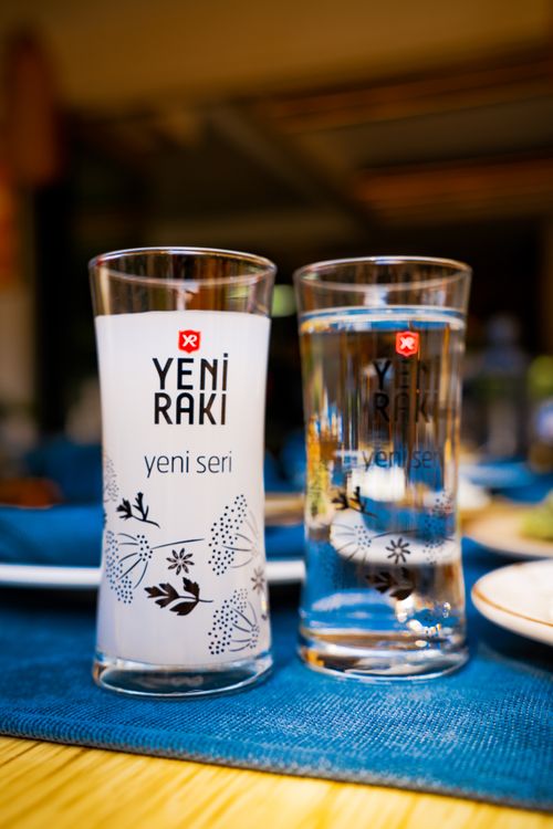 Free Close-up of two Yeni Raki glasses on a table, one filled with the Turkish alcoholic drink. Stock Photo