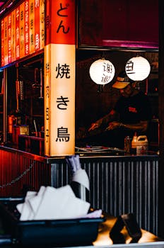 A vibrant Japanese street food stall lit by lanterns, offering an authentic culinary experience.