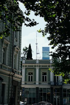 Street view of Tbilisi highlighting local architecture and the TV tower.