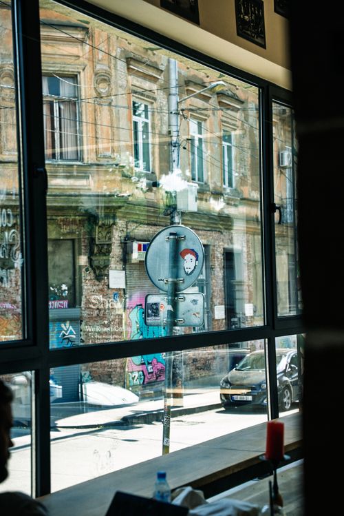 Free Urban scene of a Tbilisi street viewed through a café window, highlighting architecture. Stock Photo