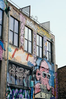 Vibrant street art covers a building facade in Tbilisi, showcasing unique urban creative expressions.