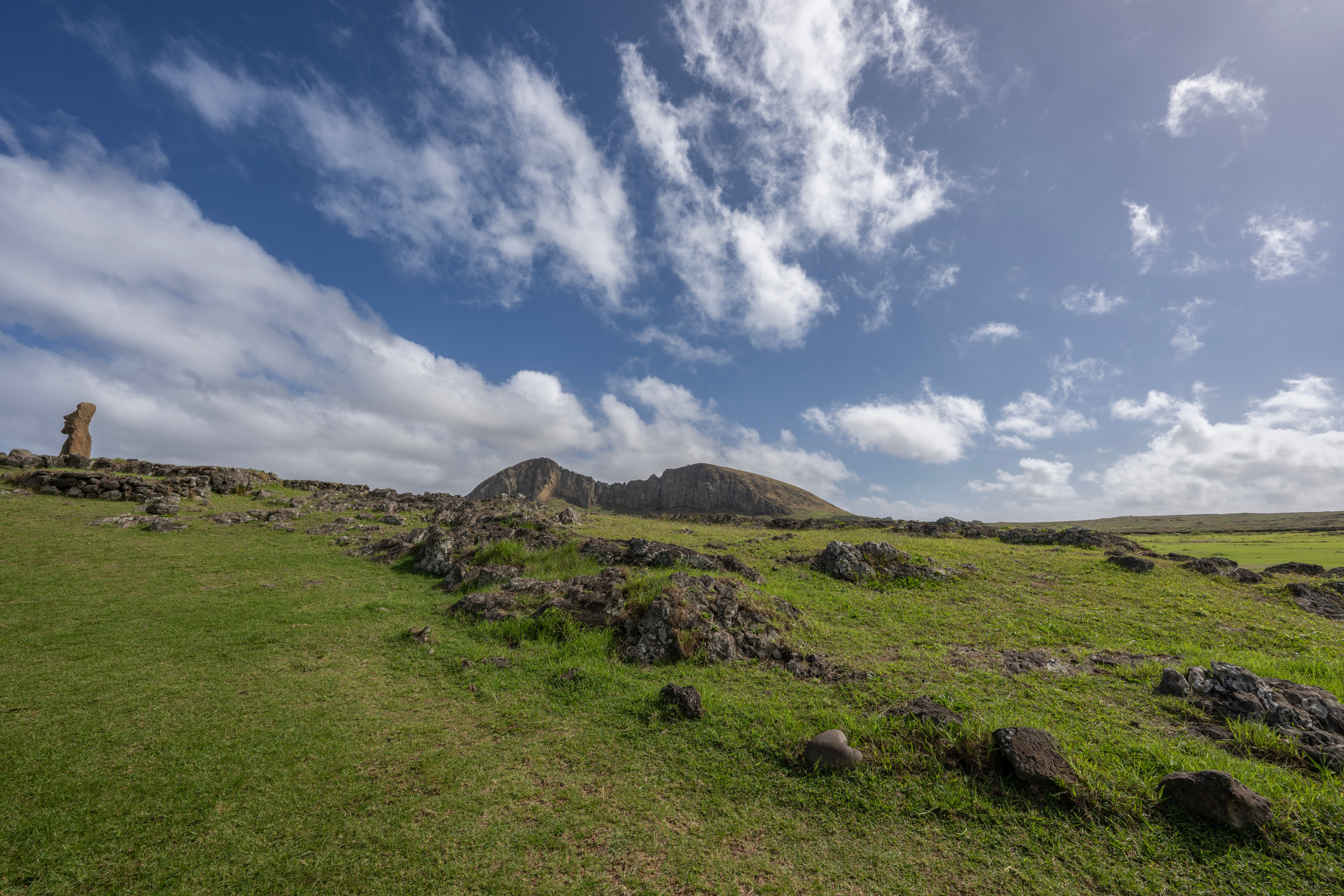 A stunning landscape view of a Moai statue at Rano Raraku on Easter Island. - Isla de Pascua