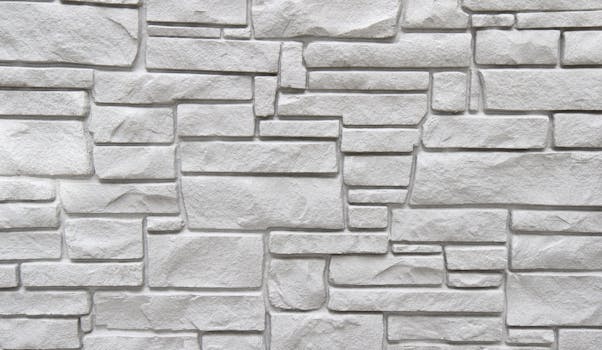 Close-up of a textured white stone wall in a minimalistic pattern, ideal for backgrounds.