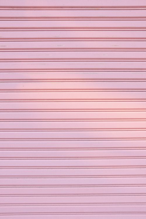 Free Minimalist pink metal shutter with even horizontal lines creating a soft pattern. Stock Photo