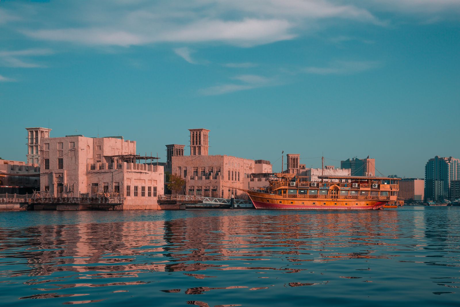 Traditional dhow on Dubai Creek at sunset