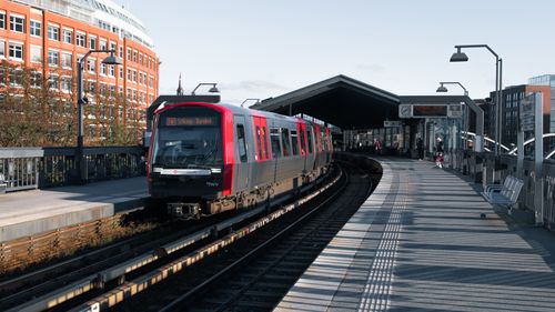 Free A commuter train arrives at a modern outdoor station in Hamburg, Germany. Stock Photo