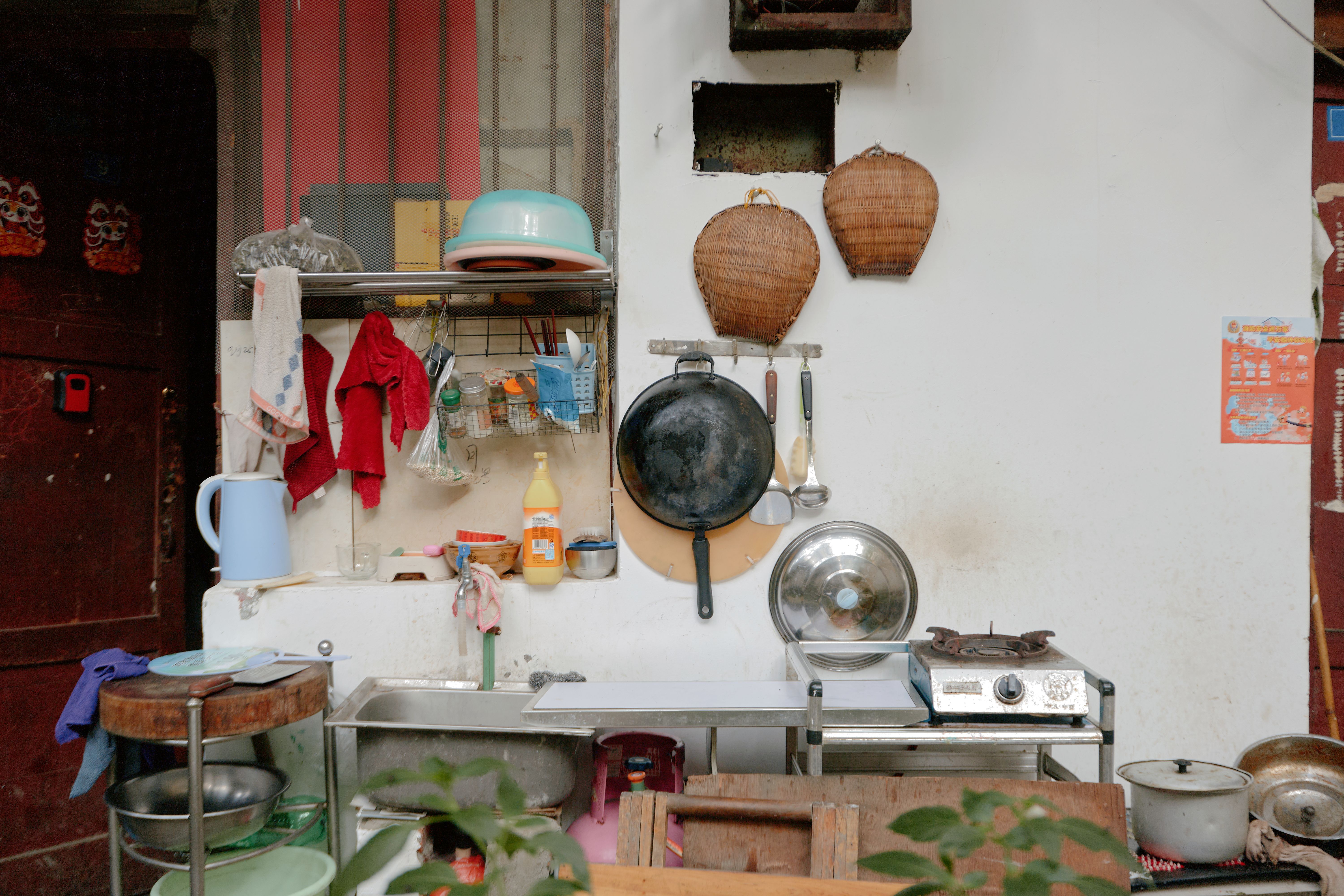 A rustic outdoor kitchen setup with traditional cooking utensils and decor, highlighting everyday life.