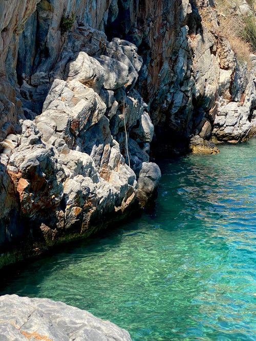 Free Vibrant coastal cliffs with clear turquoise water in Greece, showcasing natural beauty. Stock Photo