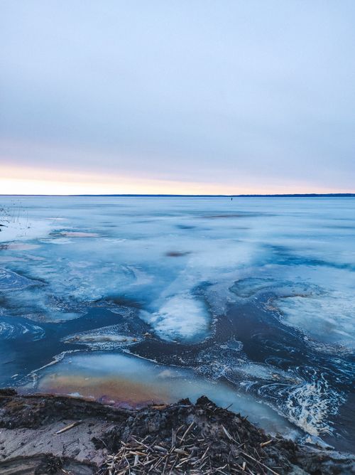 Free Stunning icy lake scene in Pereslavl-Zalessky, Russia with sunset hues. Stock Photo