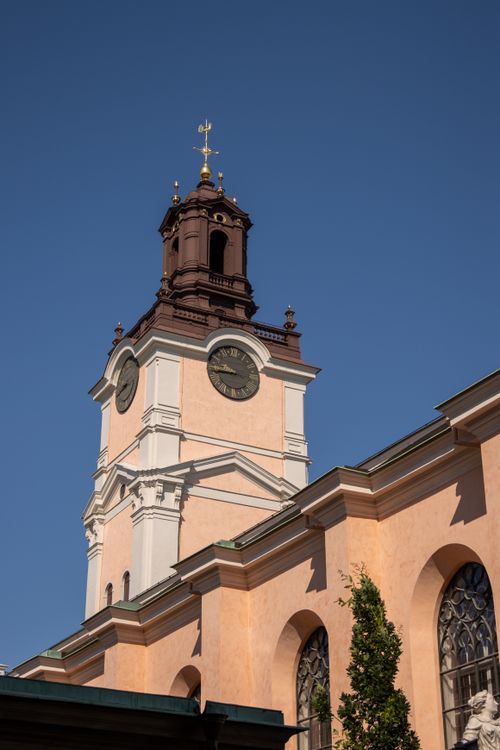 Free Historic Storkyrkan bell tower against a clear blue sky in Stockholm, Sweden. Stock Photo