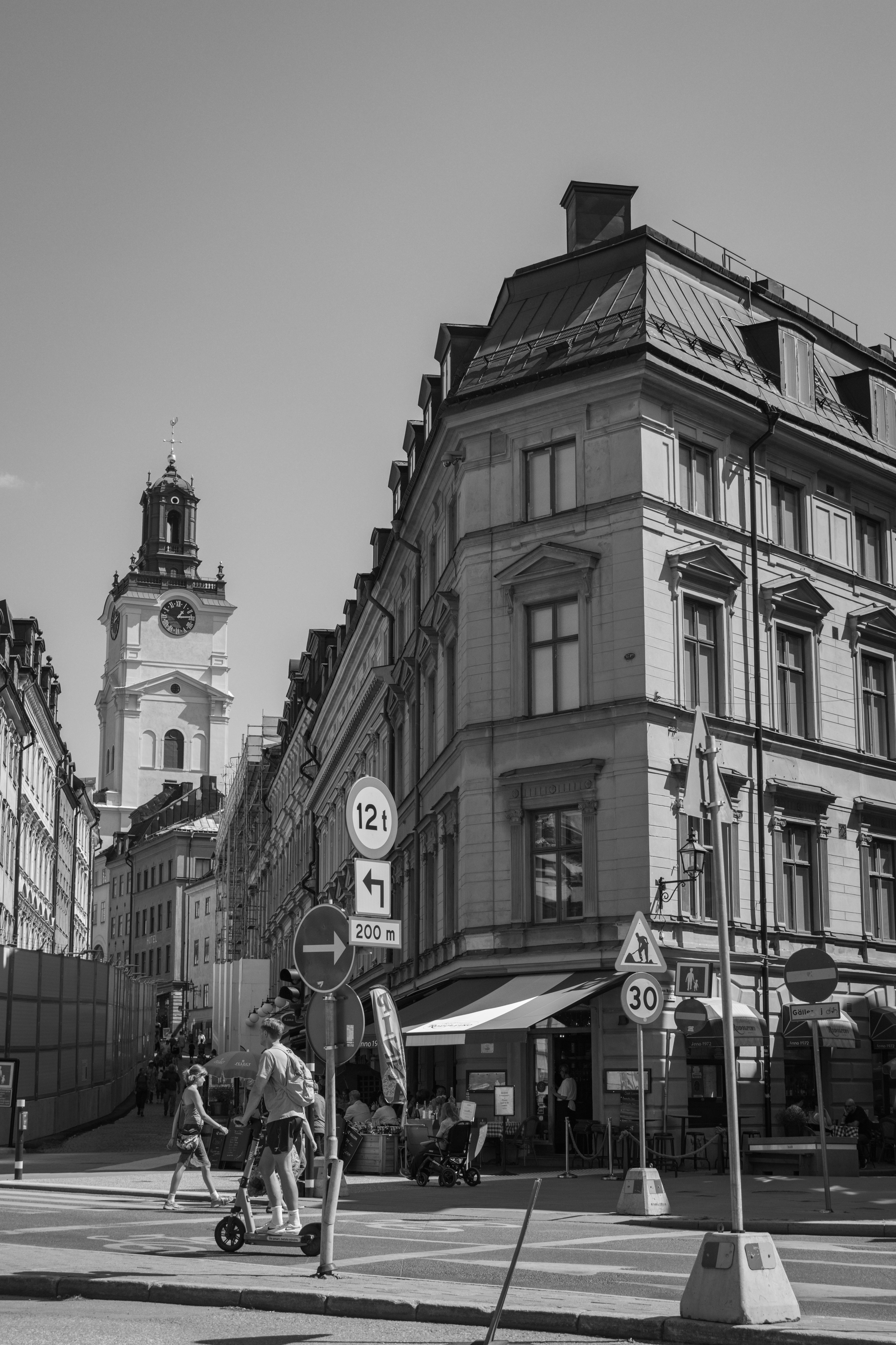Classic black and white cityscape of a street in Stockholm, Sweden, with historic architecture.