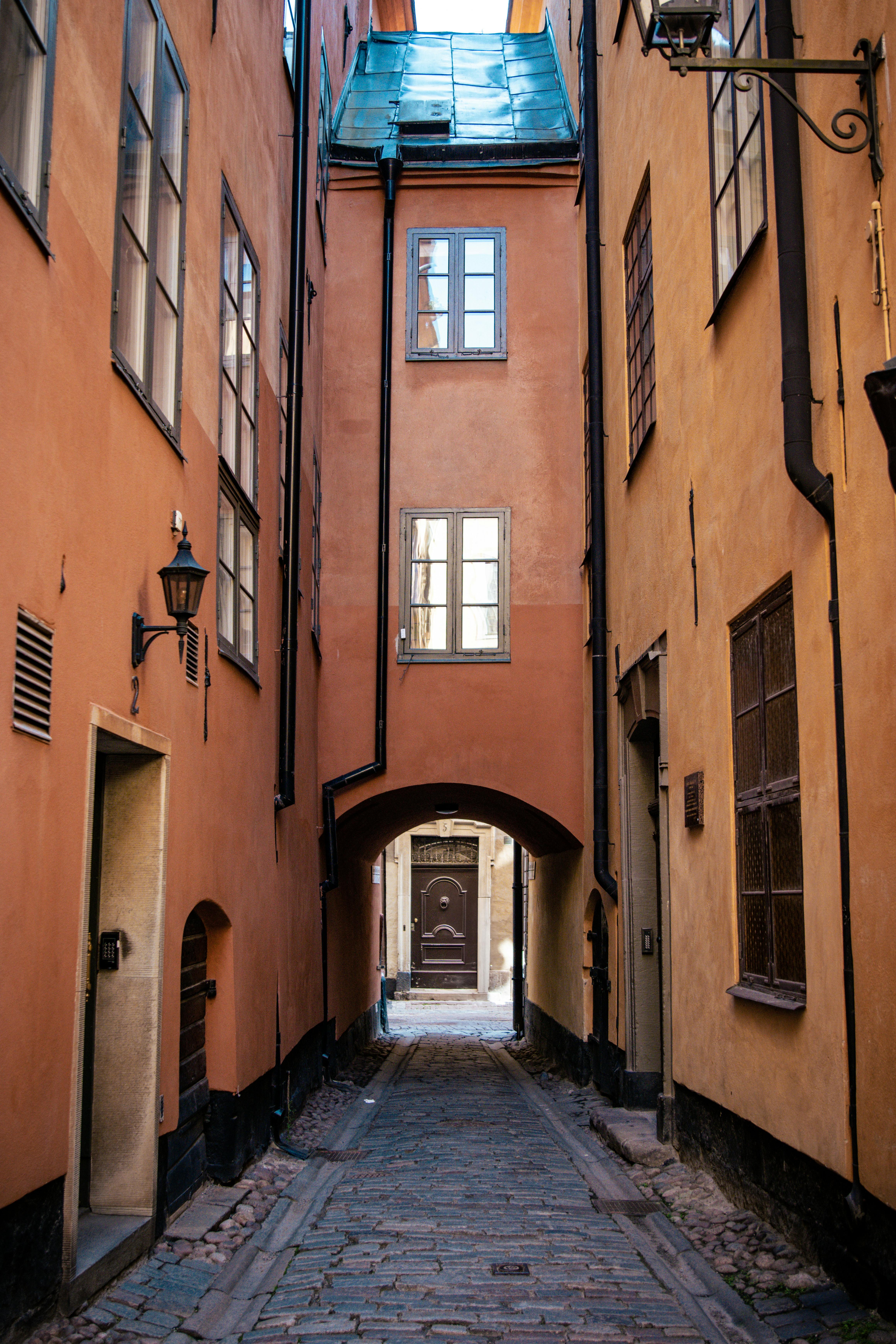 Charming narrow cobblestone street with historical buildings in Stockholm's Old Town, Sweden.