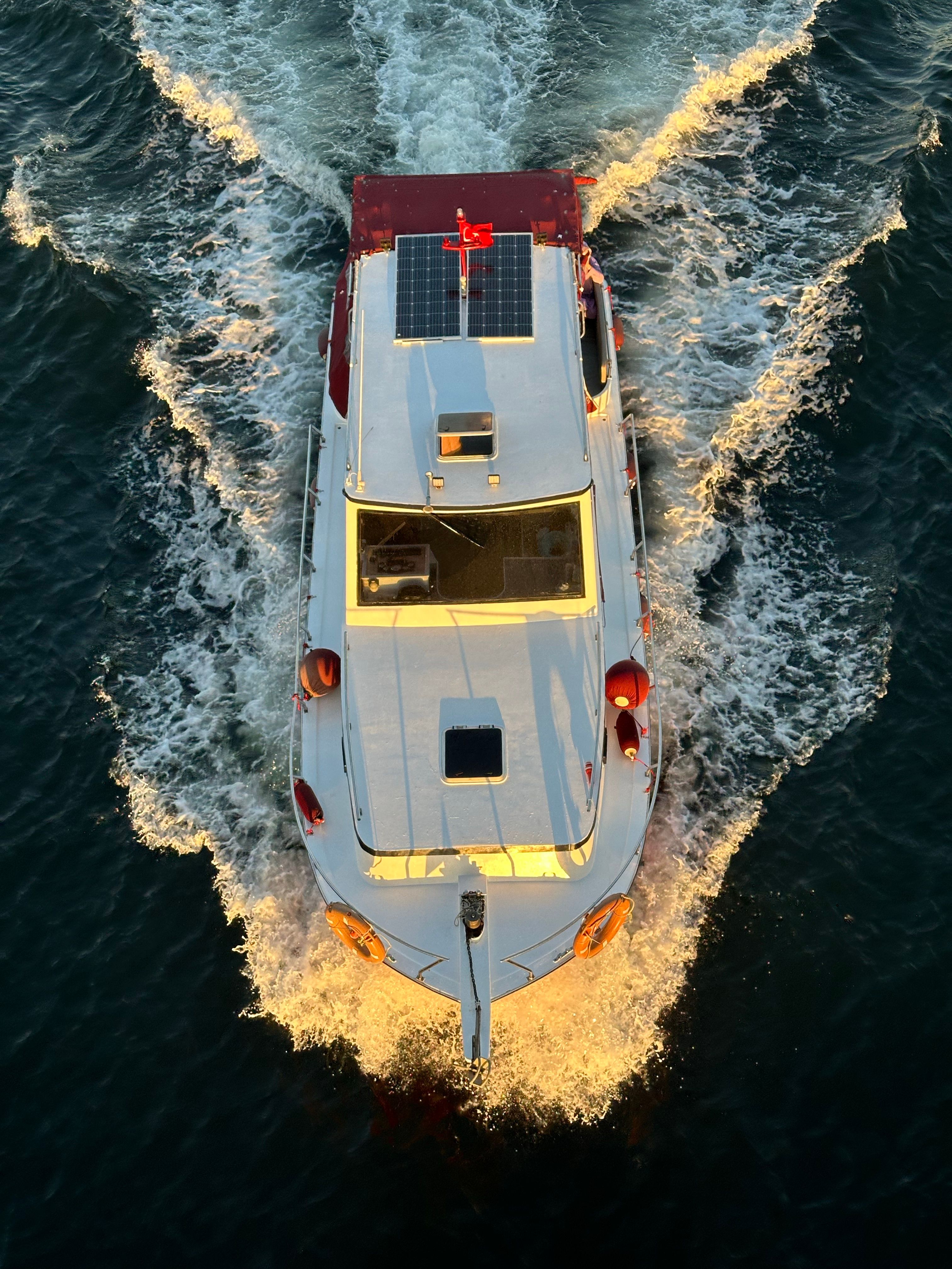 Aerial View of Motorboat with Solar Panels at Sea · Free Stock Photo