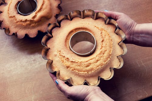 Person Holding Pan With Baked Pastry