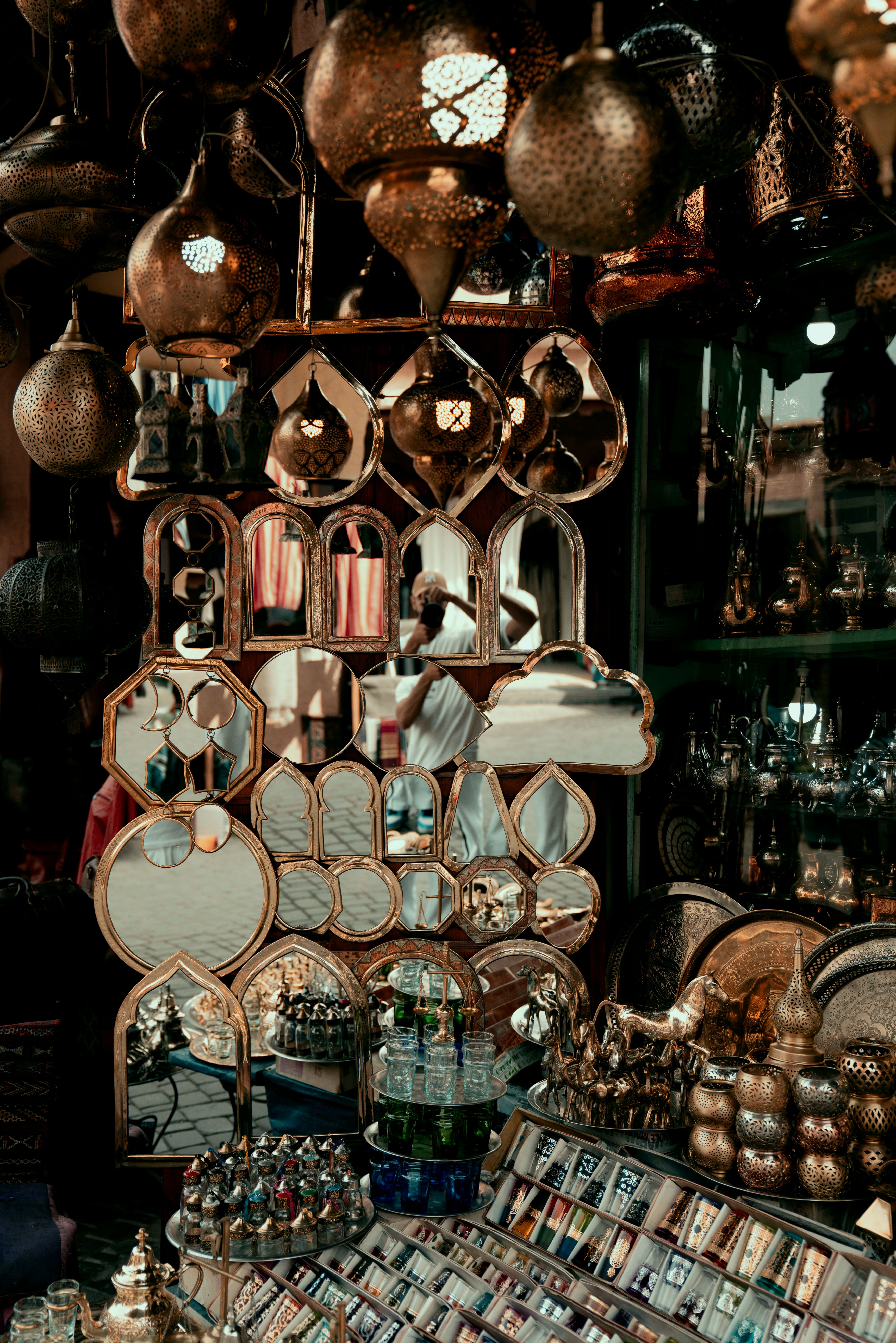 Explore a stunning display of Moroccan mirrors and lanterns in a vibrant Marrakesh market.