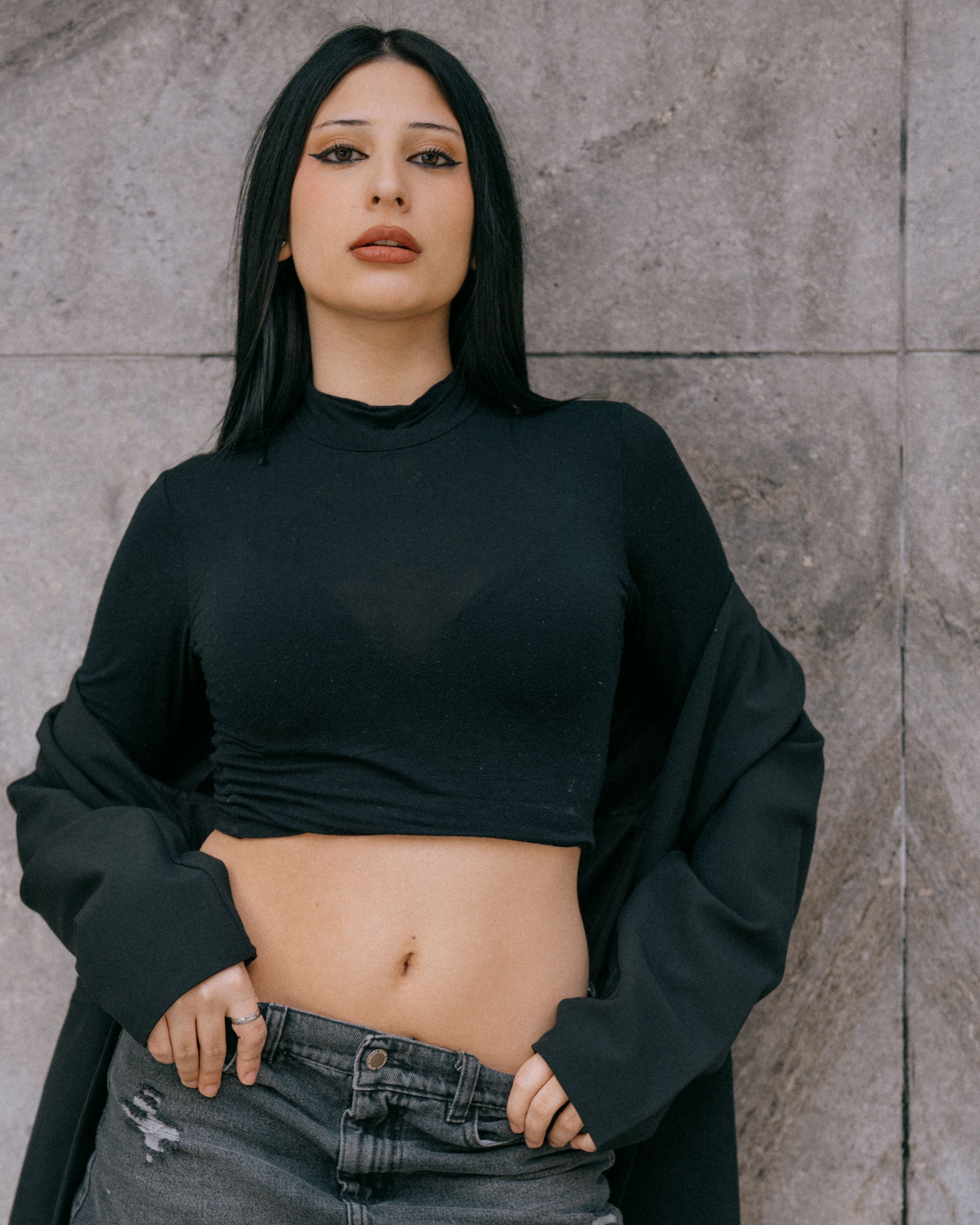 Stylish Woman in Black Top Posing Outdoors