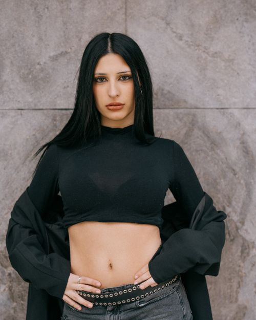 Free Stylish young woman in black outfit posing against an urban backdrop in Buenos Aires. Stock Photo