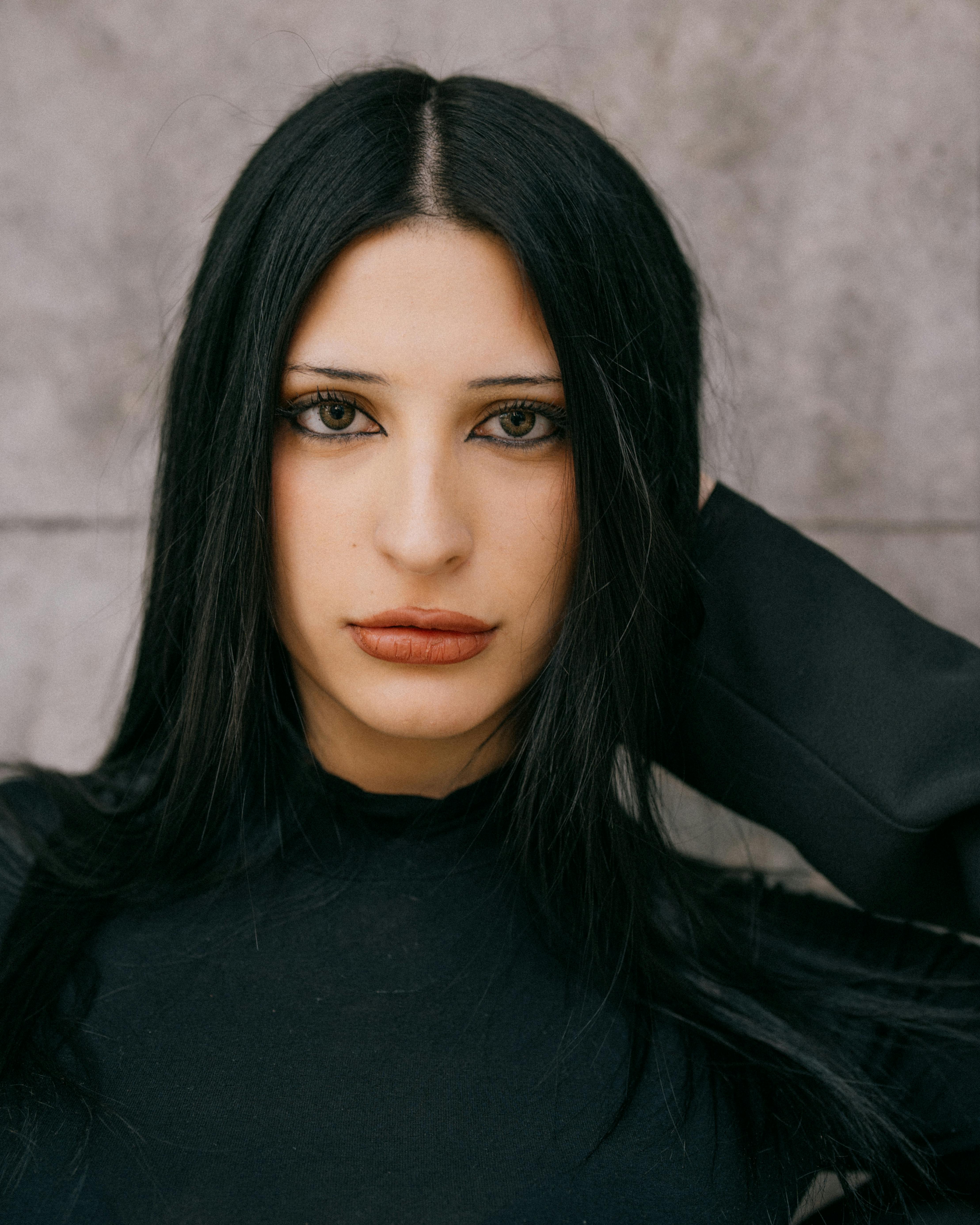 Intense close-up portrait of a woman with long dark hair in Buenos Aires, Argentina.