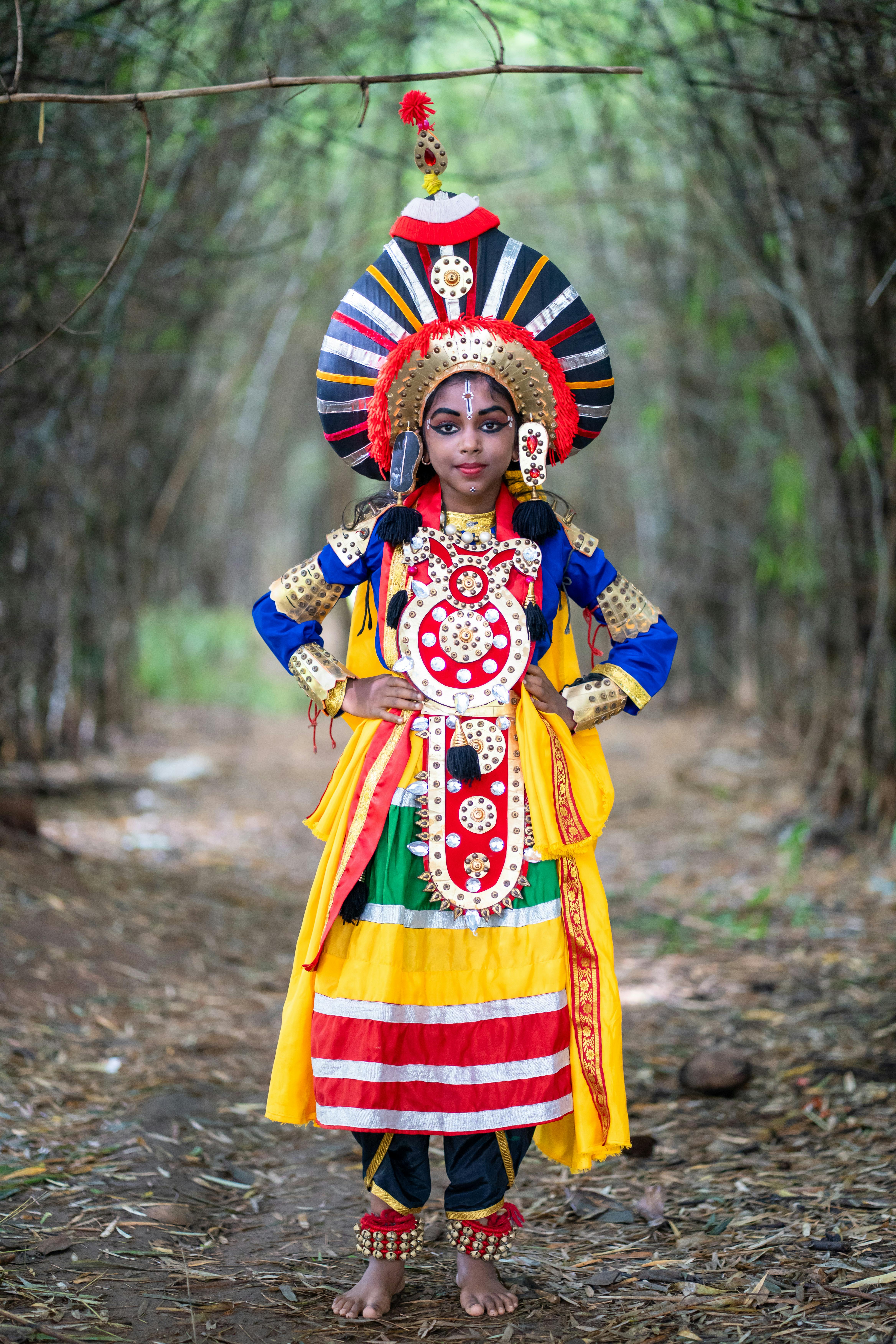 Free Traditional Yakshagana dancer in colorful costume on a forest path. Stock Photo
