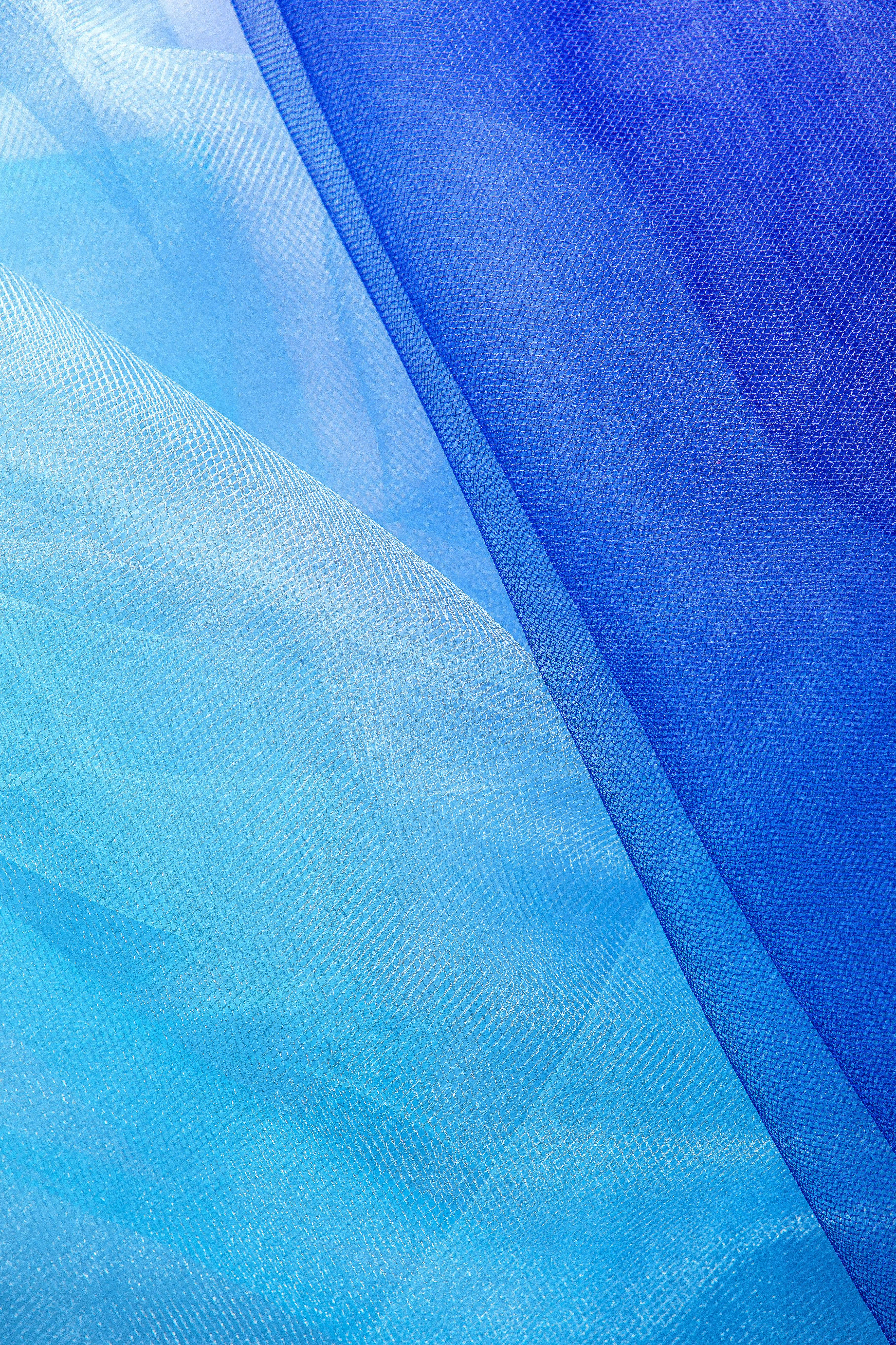 Free Close-up of abstract blue tulle fabric. Ideal for use in textile and design projects. Stock Photo