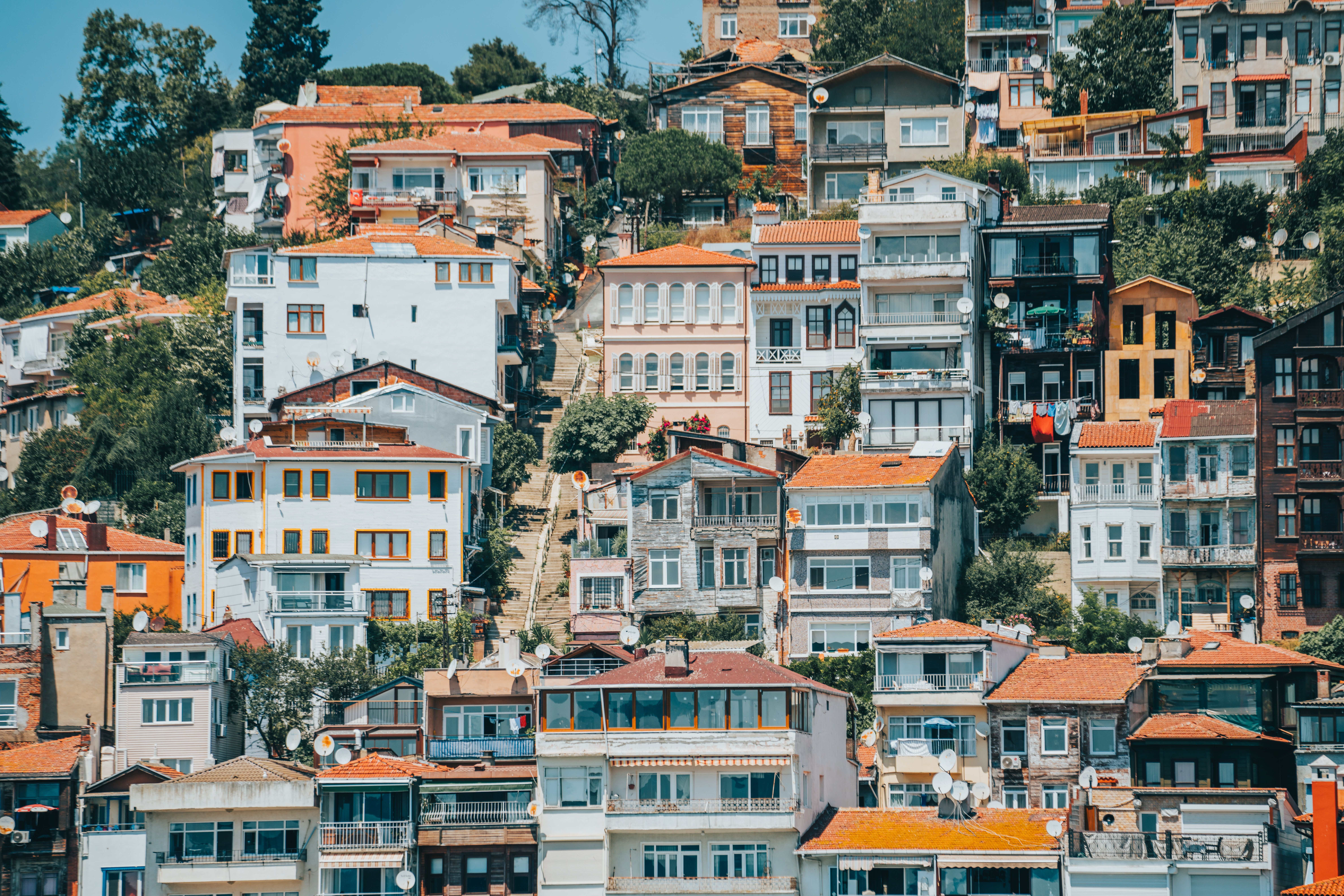 Vibrant hillside homes in Istanbul showcasing diverse architectural styles and colors.