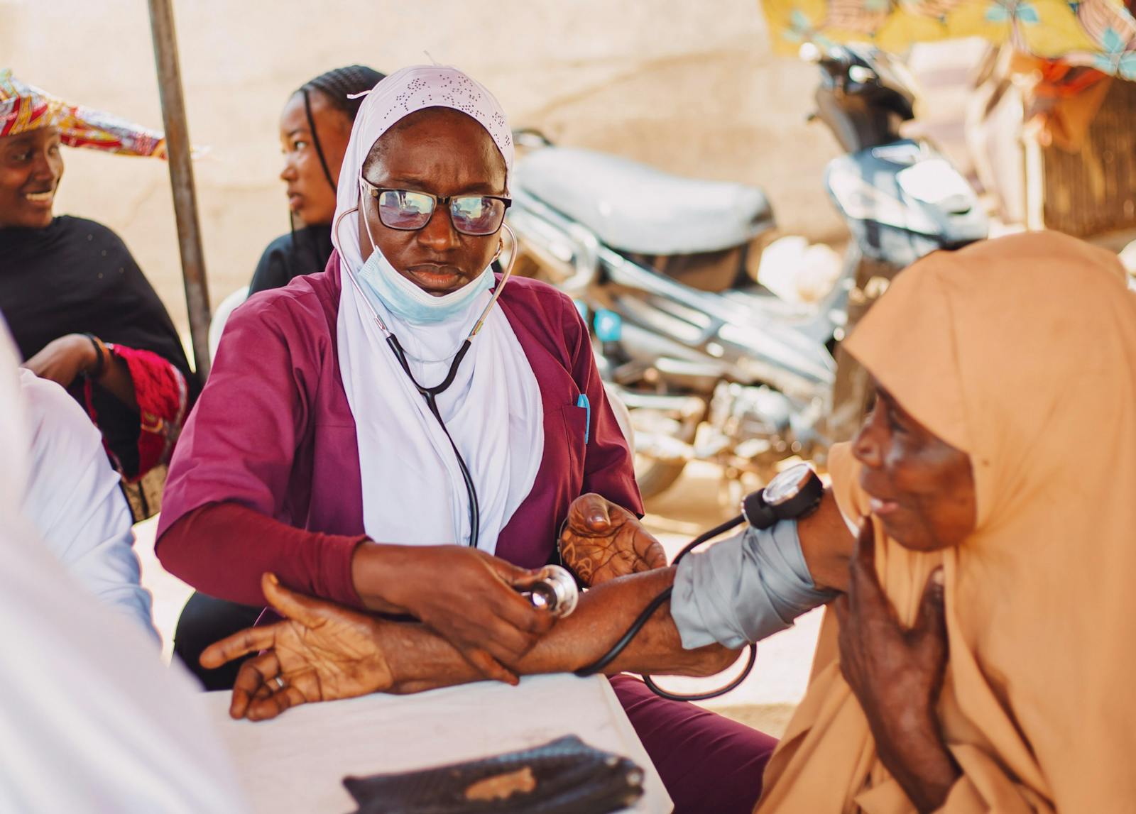 Healthcare worker assisting a patient in Kaduna, Nigeria