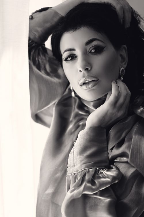 Free Stunning black and white portrait of a glamorous woman in silk attire, exuding elegance. Stock Photo
