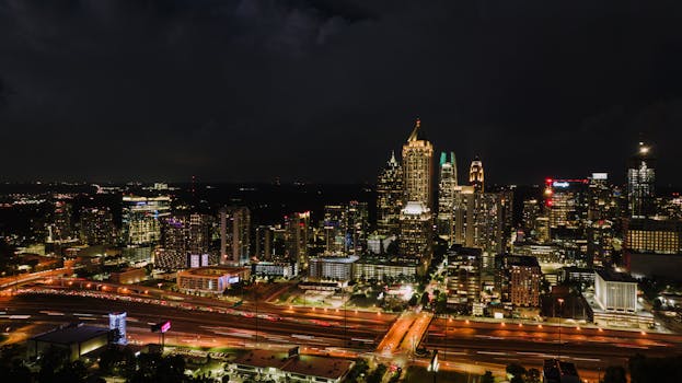 Discover the vibrant Atlanta skyline at night, showcasing the city's illuminated skyscrapers and bustling streets.