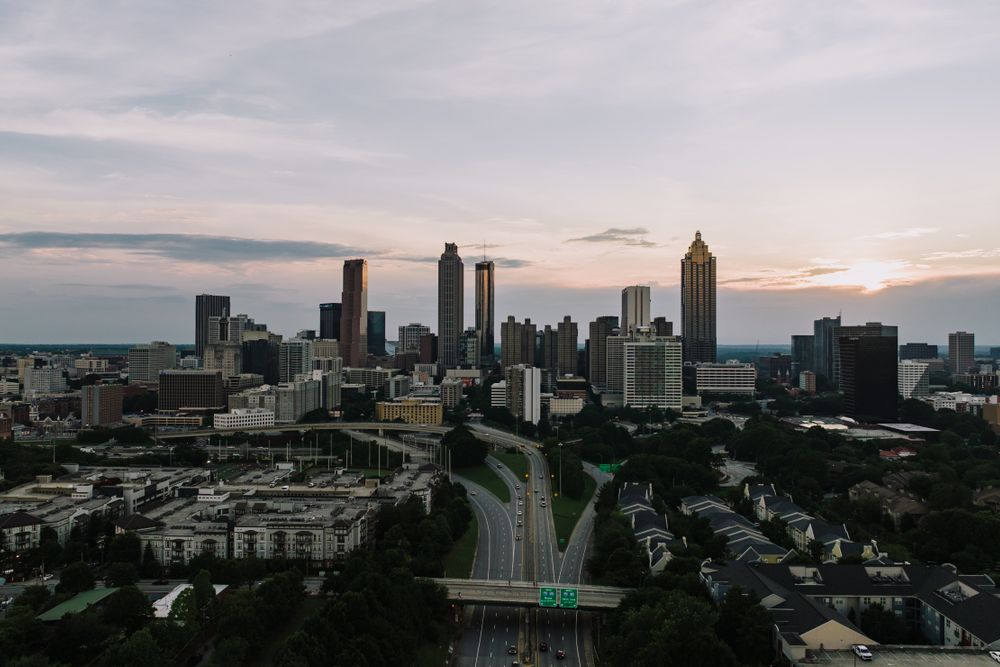 Captivating aerial view of the Atlanta skyline at dusk, showcasing the city's iconic skyscrapers and bustling highways.