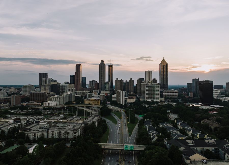 Captivating aerial view of the Atlanta skyline at dusk, showcasing the city's iconic skyscrapers and bustling highways.