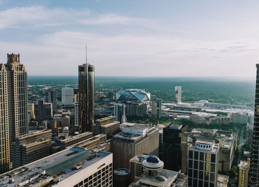 Breathtaking aerial view of Atlanta's skyline showcasing iconic buildings under a clear sky.